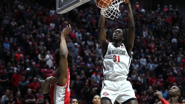 Feb 11, 2023; San Diego, California, USA; San Diego State Aztecs forward Nathan Mensah (31) dunks the ball during the first half against the UNLV Rebels at Viejas Arena. Mandatory Credit: Orlando Ramirez-USA TODAY Sports