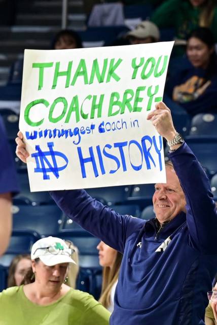 Feb 11, 2023; South Bend, Indiana, USA; A fan holds a sign thanking Notre Dame Fighting Irish head coach Mike Brey during the game against the Virginia Tech Hokies at the Purcell Pavilion. Brey announced he is stepping down from coaching at Notre Dame at the end of the season. Mandatory Credit: Matt Cashore-USA TODAY Sports