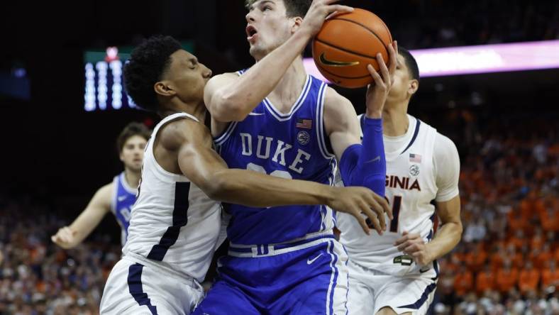 Feb 11, 2023; Charlottesville, Virginia, USA; Duke Blue Devils center Kyle Filipowski (30) drives to the basket as Virginia Cavaliers guard Ryan Dunn (13) defends in the first half at John Paul Jones Arena. Mandatory Credit: Geoff Burke-USA TODAY Sports