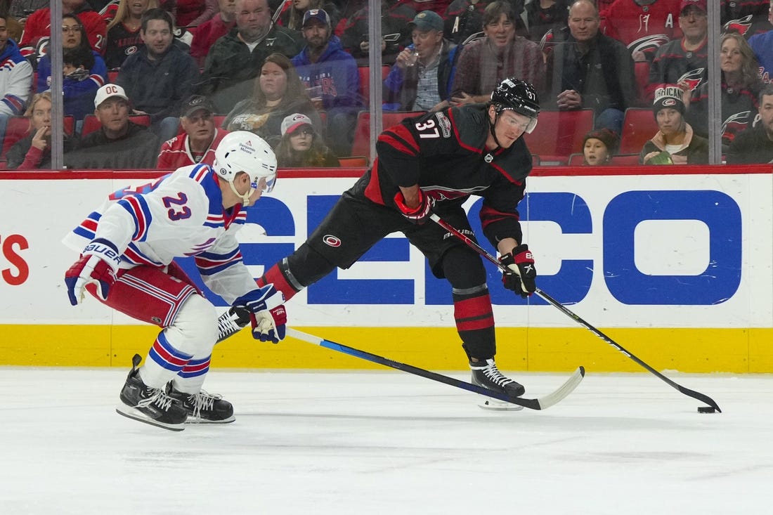 Feb 11, 2023; Raleigh, North Carolina, USA;  Carolina Hurricanes right wing Andrei Svechnikov (37) gets ready to take a shot past New York Rangers defenseman Adam Fox (23) during the first period at PNC Arena. Mandatory Credit: James Guillory-USA TODAY Sports