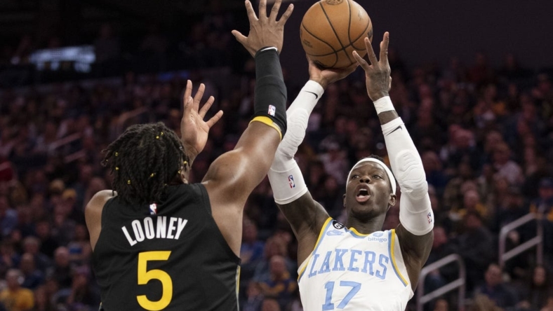 February 11, 2023; San Francisco, California, USA; Los Angeles Lakers guard Dennis Schroder (17) shoots the basketball against Golden State Warriors forward Kevon Looney (5) during the fourth quarter at Chase Center. Mandatory Credit: Kyle Terada-USA TODAY Sports