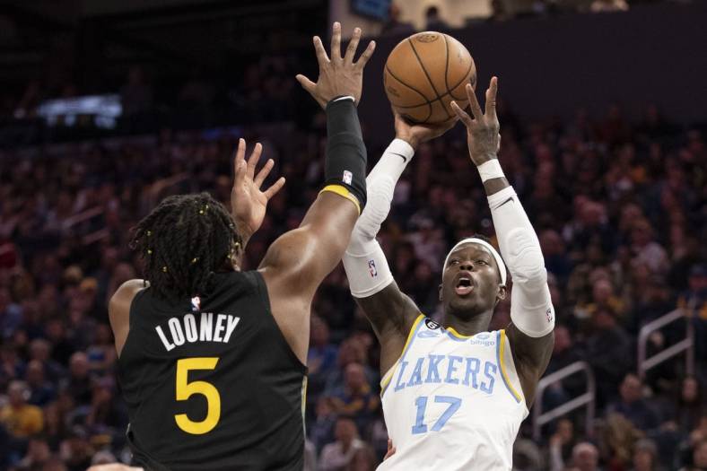 February 11, 2023; San Francisco, California, USA; Los Angeles Lakers guard Dennis Schroder (17) shoots the basketball against Golden State Warriors forward Kevon Looney (5) during the fourth quarter at Chase Center. Mandatory Credit: Kyle Terada-USA TODAY Sports