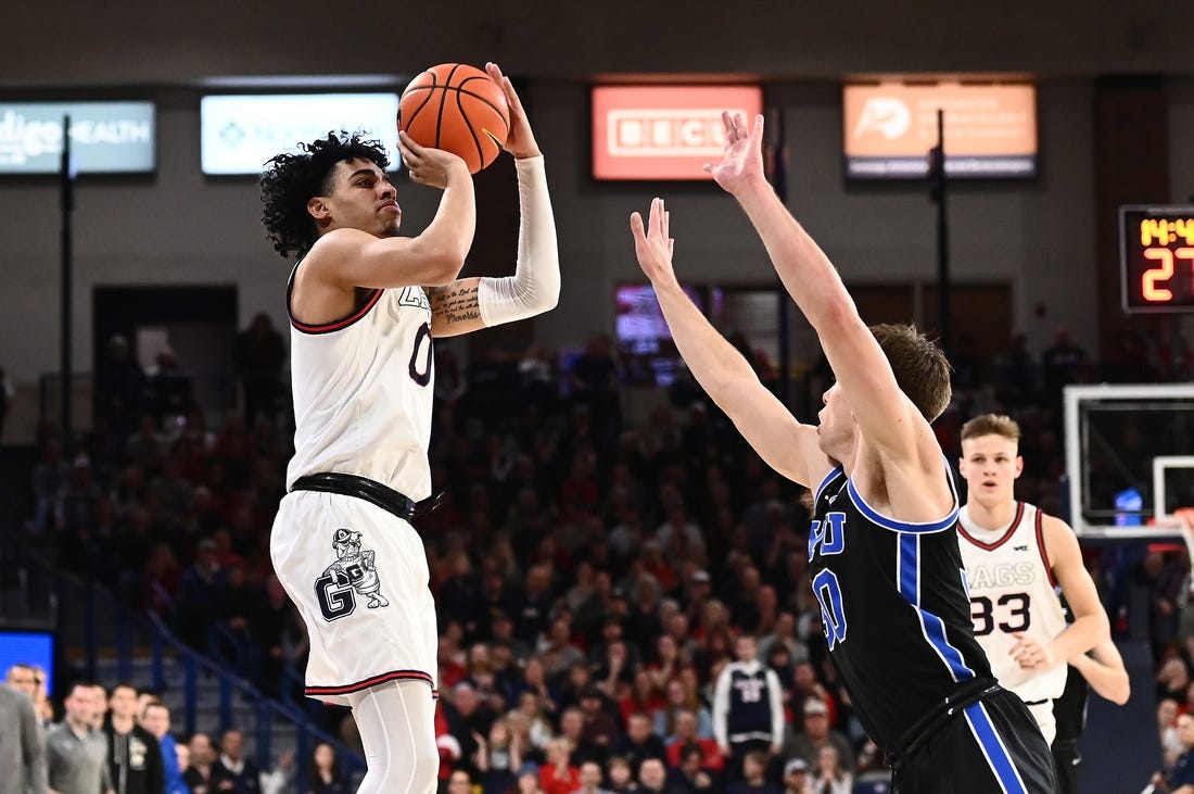 Feb 11, 2023; Spokane, Washington, USA; Gonzaga Bulldogs guard Julian Strawther (0) shoots the ball against Brigham Young Cougars guard Dallin Hall (30) in the second half at McCarthey Athletic Center. Gonzaga won 88-81. Mandatory Credit: James Snook-USA TODAY Sports