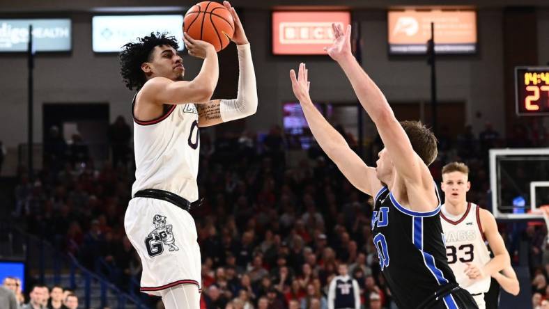 Feb 11, 2023; Spokane, Washington, USA; Gonzaga Bulldogs guard Julian Strawther (0) shoots the ball against Brigham Young Cougars guard Dallin Hall (30) in the second half at McCarthey Athletic Center. Gonzaga won 88-81. Mandatory Credit: James Snook-USA TODAY Sports