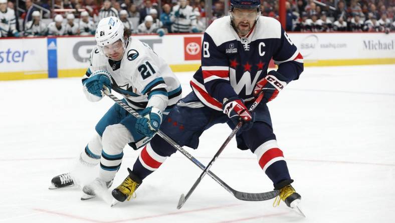 Feb 12, 2023; Washington, District of Columbia, USA; Washington Capitals left wing Alex Ovechkin (8) battles for the puck with San Jose Sharks center Michael Eyssimont (21) in the third period at Capital One Arena. Mandatory Credit: Geoff Burke-USA TODAY Sports