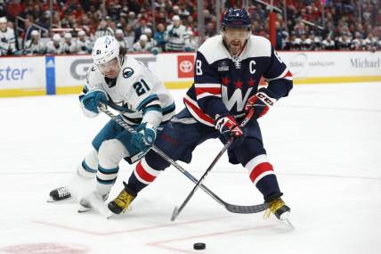 Feb 12, 2023; Washington, District of Columbia, USA; Washington Capitals left wing Alex Ovechkin (8) battles for the puck with San Jose Sharks center Michael Eyssimont (21) in the third period at Capital One Arena. Mandatory Credit: Geoff Burke-USA TODAY Sports