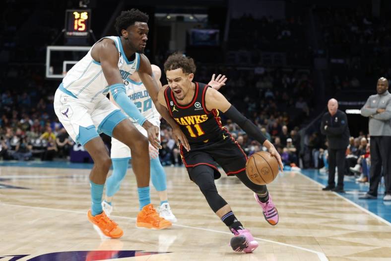 Feb 13, 2023; Charlotte, North Carolina, USA; Atlanta Hawks guard Trae Young (11) drives past Charlotte Hornets center Mark Williams (5) during the first quarter at Spectrum Center. Mandatory Credit: Brian Westerholt-USA TODAY Sports