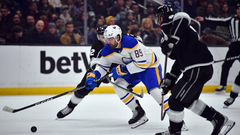 Feb 13, 2023; Los Angeles, California, USA; Buffalo Sabres right wing Alex Tuch (89) moves the puck against Los Angeles Kings defenseman Alexander Edler (2) and defenseman Drew Doughty (8) during the first period at Crypto.com Arena. Mandatory Credit: Gary A. Vasquez-USA TODAY Sports