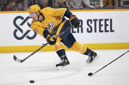 Feb 13, 2023; Nashville, Tennessee USA; Nashville Predators center Ryan Johansen (92) passes the puck across the ice during the first period of the game against the Arizona Coyotes at Bridgestone Arena. Mandatory Credit: George Walker IV - USA TODAY Sports