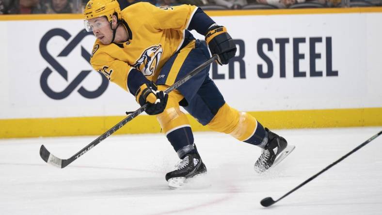 Feb 13, 2023; Nashville, Tennessee USA; Nashville Predators center Ryan Johansen (92) passes the puck across the ice during the first period of the game against the Arizona Coyotes at Bridgestone Arena. Mandatory Credit: George Walker IV - USA TODAY Sports