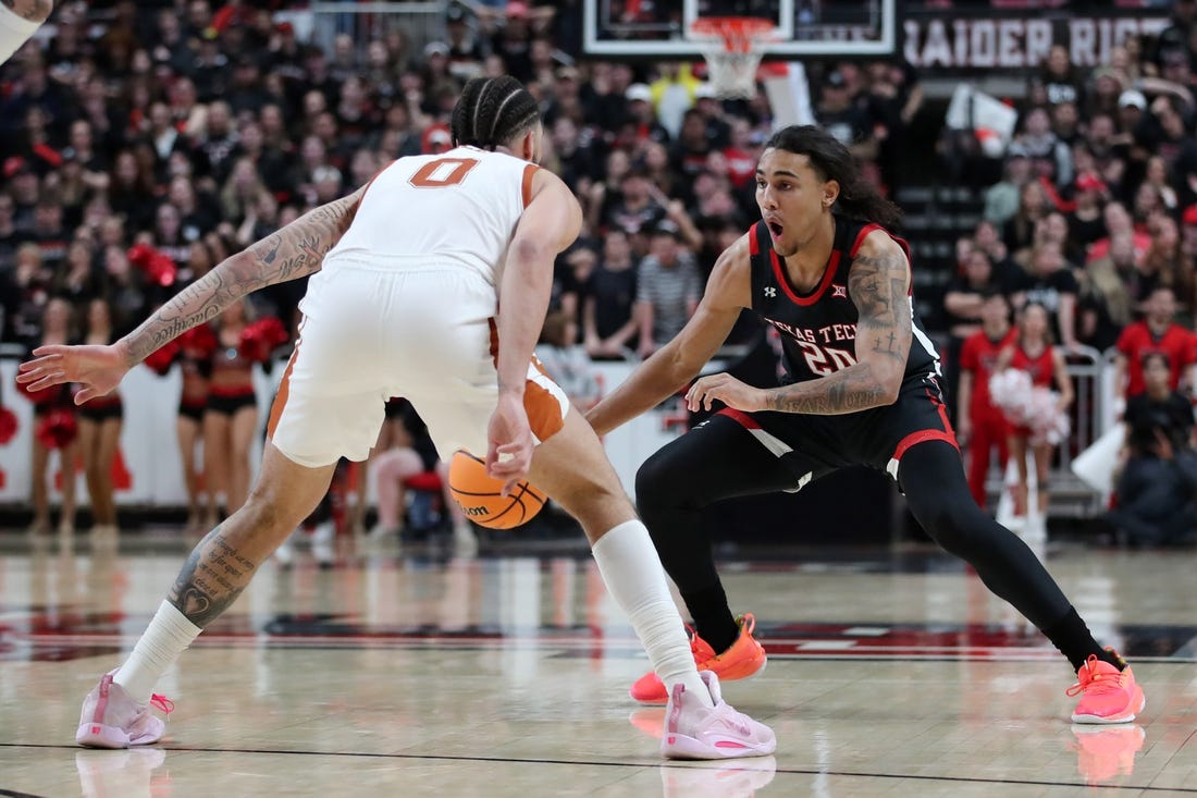 Feb 13, 2023; Lubbock, Texas, USA;  Texas Tech Red Raiders forward Jaylon Tyson (20) works the ball against Texas Longhorns forward Timmy Allen (0) in the second half at United Supermarkets Arena. Mandatory Credit: Michael C. Johnson-USA TODAY Sports