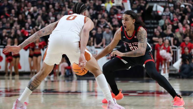 Feb 13, 2023; Lubbock, Texas, USA;  Texas Tech Red Raiders forward Jaylon Tyson (20) works the ball against Texas Longhorns forward Timmy Allen (0) in the second half at United Supermarkets Arena. Mandatory Credit: Michael C. Johnson-USA TODAY Sports