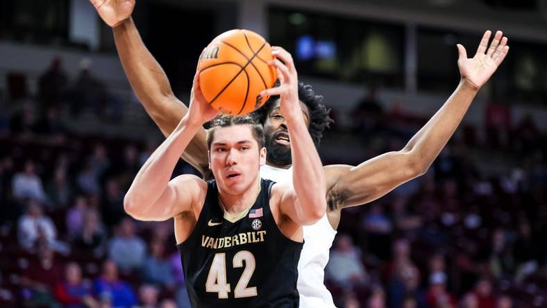 Feb 14, 2023; Columbia, South Carolina, USA; Vanderbilt Commodores forward Quentin Millora-Brown (42) grabs a rebound over South Carolina Gamecocks forward Josh Gray (33) in the first half at Colonial Life Arena. Mandatory Credit: Jeff Blake-USA TODAY Sports