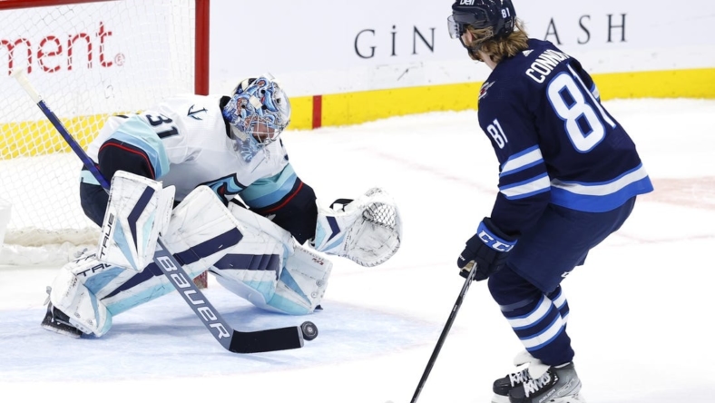 Feb 14, 2023; Winnipeg, Manitoba, CAN; Seattle Kraken goaltender Philipp Grubauer (31) stops a shot by Winnipeg Jets left wing Kyle Connor (81) in the shoot out at Canada Life Centre. Mandatory Credit: James Carey Lauder-USA TODAY Sports