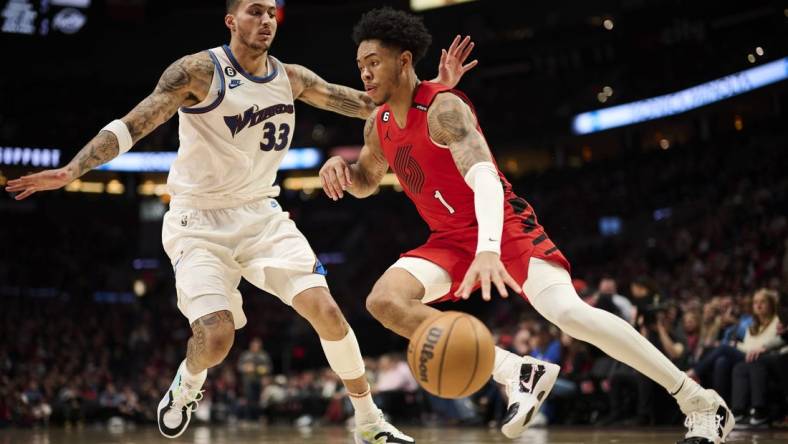 Feb 14, 2023; Portland, Oregon, USA; Portland Trail Blazers guard Anfernee Simons (1) drives to the basket during the second half against Washington Wizards forward Kyle Kuzma (33) at Moda Center. Mandatory Credit: Troy Wayrynen-USA TODAY Sports