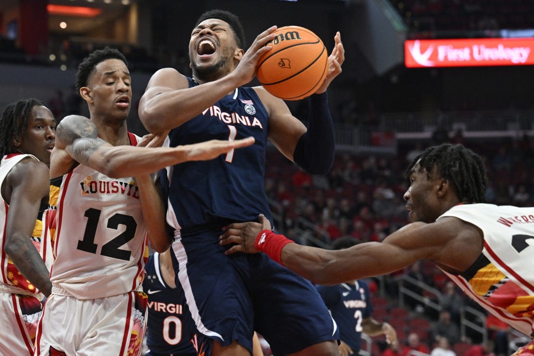 Feb 15, 2023; Louisville, Kentucky, USA;  Virginia Cavaliers forward Jayden Gardner (1) drives to the basket against Louisville Cardinals forward JJ Traynor (12) and Louisville Cardinals forward Jae'Lyn Withers (24) during the first half at KFC Yum! Center. Mandatory Credit: Jamie Rhodes-USA TODAY Sports