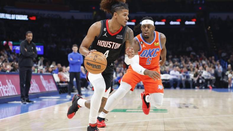 Feb 15, 2023; Oklahoma City, Oklahoma, USA; Houston Rockets guard Jalen Green (4) drives down the court ahead of Oklahoma City Thunder guard Luguentz Dort (5) during the first quarter at Paycom Center. Mandatory Credit: Alonzo Adams-USA TODAY Sports