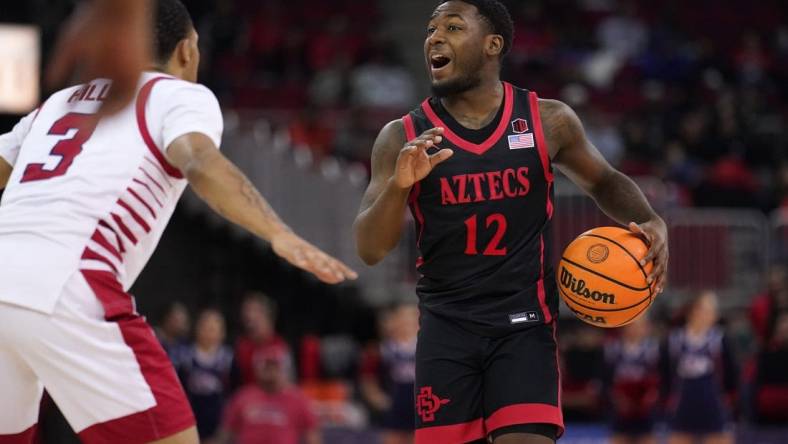 Feb 15, 2023; Fresno, California, USA; San Diego State Aztecs guard Darrion Trammell (12) dribbles the ball against the Fresno State Bulldogs in the first half at the Save Mart Center. Mandatory Credit: Cary Edmondson-USA TODAY Sports