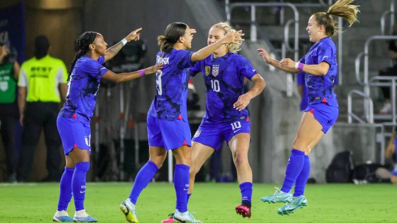 Feb 16, 2023; Orlando, Florida, USA; USA forward Mallory Swanson (9) celebrates with teammates after scoring a goal during the first half against Canada at Exploria Stadium. Mandatory Credit: Mike Watters-USA TODAY Sports