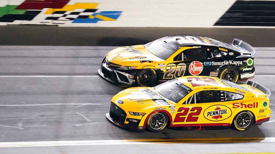 Feb 16, 2023; Daytona Beach, Florida, USA; NASCAR Cup Series driver Joey Logano (22) races to win crossing the finish line ahead of driver Christopher Bell (20) winning the Bluegreen Vacations Duel 1 at Daytona International Speedway. Mandatory Credit: John David Mercer-USA TODAY Sports