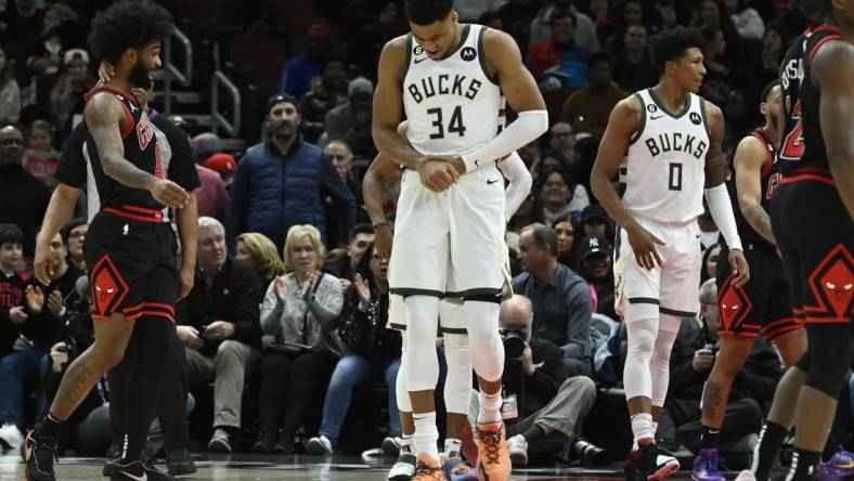 Feb 16, 2023; Chicago, Illinois, USA;  Milwaukee Bucks forward Giannis Antetokounmpo (34) holds his wrist after colliding with Chicago Bulls guard Coby White (not pictured) during the first half at the United Center. Mandatory Credit: Matt Marton-USA TODAY Sports