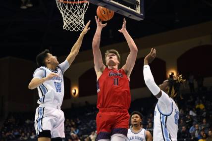 Feb 16, 2023; San Diego, California, USA; Saint Mary's Gaels center Mitchell Saxen (11) shoots the ball while defended by San Diego Toreros guard Neel Beniwal (15) during the first half at Jenny Craig Pavilion. Mandatory Credit: Orlando Ramirez-USA TODAY Sports