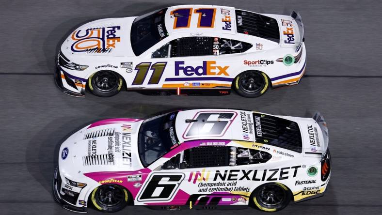 Feb 16, 2023; Daytona Beach, Florida, USA; NASCAR Cup Series driver Brad Keselowski (6) and driver Denny Hamlin (11) race side by side during Duel 2 at Daytona International Speedway. Mandatory Credit: Mike Dinovo-USA TODAY Sports