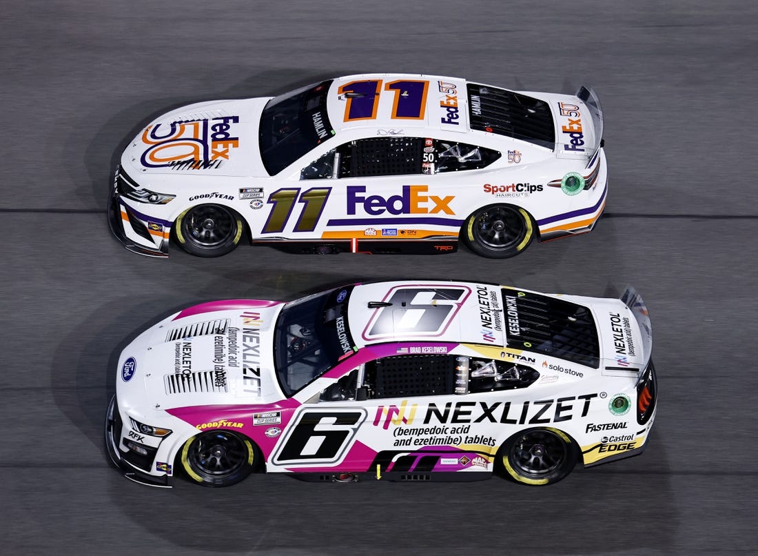 Feb 16, 2023; Daytona Beach, Florida, USA; NASCAR Cup Series driver Brad Keselowski (6) and driver Denny Hamlin (11) race side by side during Duel 2 at Daytona International Speedway. Mandatory Credit: Mike Dinovo-USA TODAY Sports