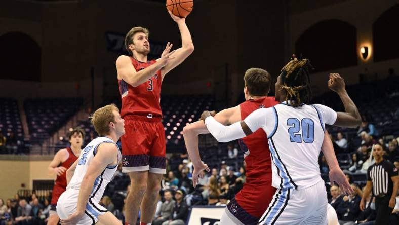 Feb 16, 2023; San Diego, California, USA; Saint Mary's Gaels guard Augustas Marciulionis (3) shoots the ball over San Diego Toreros guard Dominic Muncey (32) during the first half at Jenny Craig Pavilion. Mandatory Credit: Orlando Ramirez-USA TODAY Sports