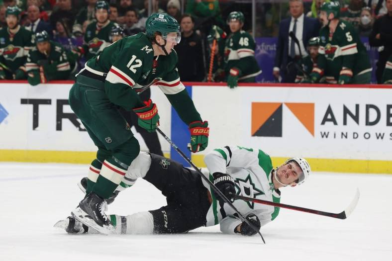 Feb 17, 2023; Saint Paul, Minnesota, USA;  Dallas Stars left wing Mason Marchment (27) is hit by Minnesota Wild left wing Matt Boldy (12) during the first period at Xcel Energy Center. Mandatory Credit: Bruce Fedyck-USA TODAY Sports