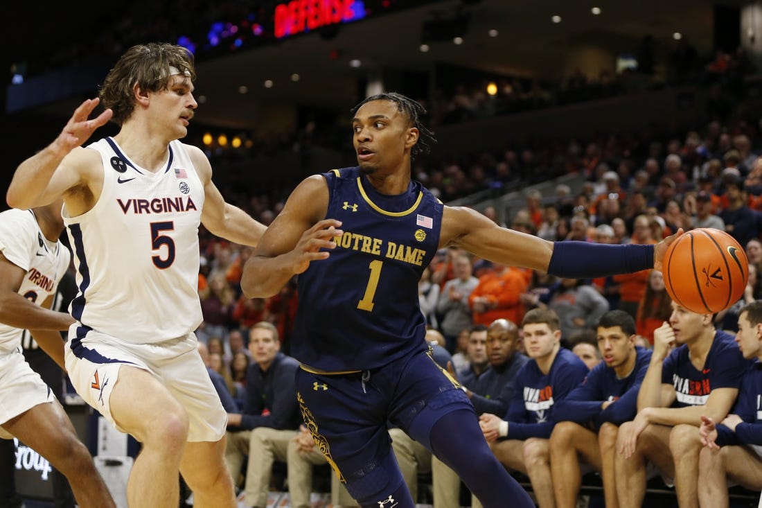 Feb 18, 2023; Charlottesville, Virginia, USA; Notre Dame Fighting Irish guard J.J. Starling (1) controls the ball as Virginia Cavaliers forward Ben Vander Plas (5) defends during the first half at John Paul Jones Arena. Mandatory Credit: Amber Searls-USA TODAY Sports