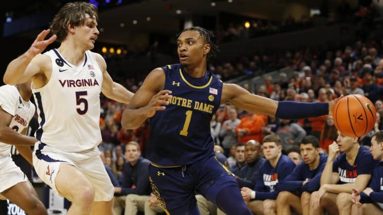 Feb 18, 2023; Charlottesville, Virginia, USA; Notre Dame Fighting Irish guard J.J. Starling (1) controls the ball as Virginia Cavaliers forward Ben Vander Plas (5) defends during the first half at John Paul Jones Arena. Mandatory Credit: Amber Searls-USA TODAY Sports