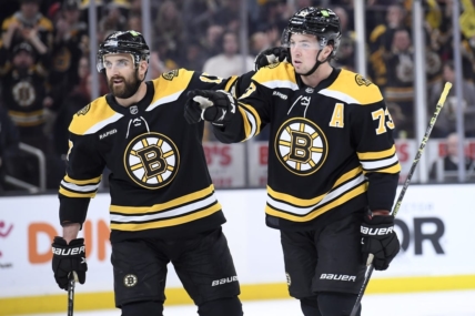 Feb 18, 2023; Boston, Massachusetts, USA;  Boston Bruins defenseman Charlie McAvoy (73) reacts with left wing Nick Foligno (17) after a tip in goal by center Trent Frederic (11) (not pictured) during the first period against the New York Islanders at TD Garden. Mandatory Credit: Bob DeChiara-USA TODAY Sports