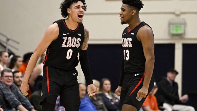 Feb 18, 2023; Malibu, California, USA; Gonzaga Bulldogs guard Julian Strawther (0) celebrates with guard Malachi Smith (13) after making a shot while being fouled against the Pepperdine Waves during the first half at Firestone Fieldhouse. Mandatory Credit: Kelvin Kuo-USA TODAY Sports