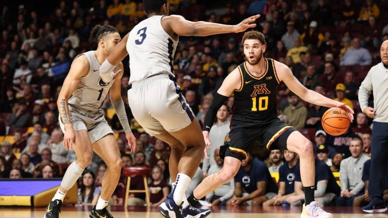 Feb 18, 2023; Minneapolis, Minnesota, USA; Minnesota Golden Gophers forward Jamison Battle (10) dribbles the ball against Penn State Nittany Lions guard Seth Lundy (1) and forward Kebba Njie (3) during the first half at Williams Arena. Mandatory Credit: Matt Krohn-USA TODAY Sports