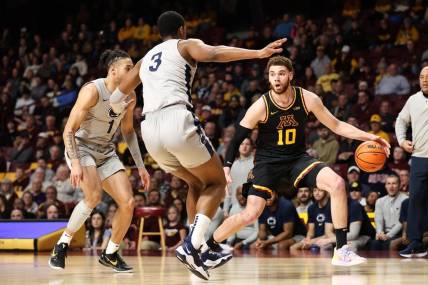 Feb 18, 2023; Minneapolis, Minnesota, USA; Minnesota Golden Gophers forward Jamison Battle (10) dribbles the ball against Penn State Nittany Lions guard Seth Lundy (1) and forward Kebba Njie (3) during the first half at Williams Arena. Mandatory Credit: Matt Krohn-USA TODAY Sports