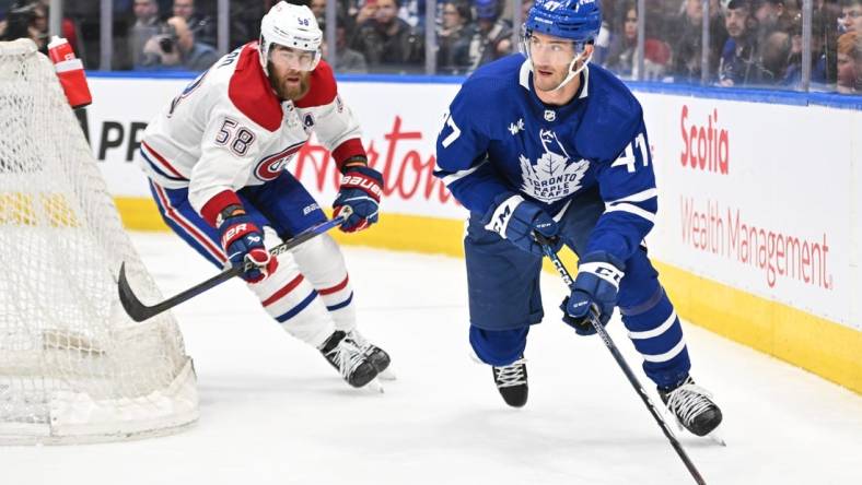 Feb 18, 2023; Toronto, Ontario, CAN;   Toronto Maple Leafs forward Pierre Engvall (47) carries the puck away from Montreal Canadiens defenseman David Savard (58) in the third period at Scotiabank Arena. Mandatory Credit: Dan Hamilton-USA TODAY Sports