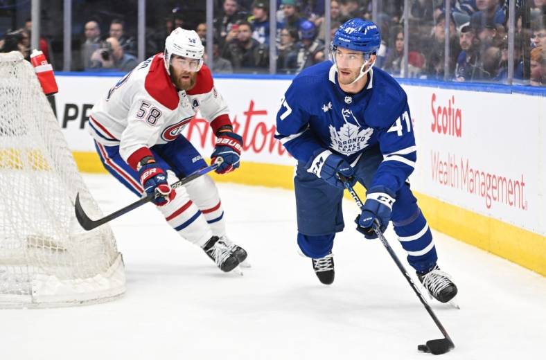Feb 18, 2023; Toronto, Ontario, CAN;   Toronto Maple Leafs forward Pierre Engvall (47) carries the puck away from Montreal Canadiens defenseman David Savard (58) in the third period at Scotiabank Arena. Mandatory Credit: Dan Hamilton-USA TODAY Sports