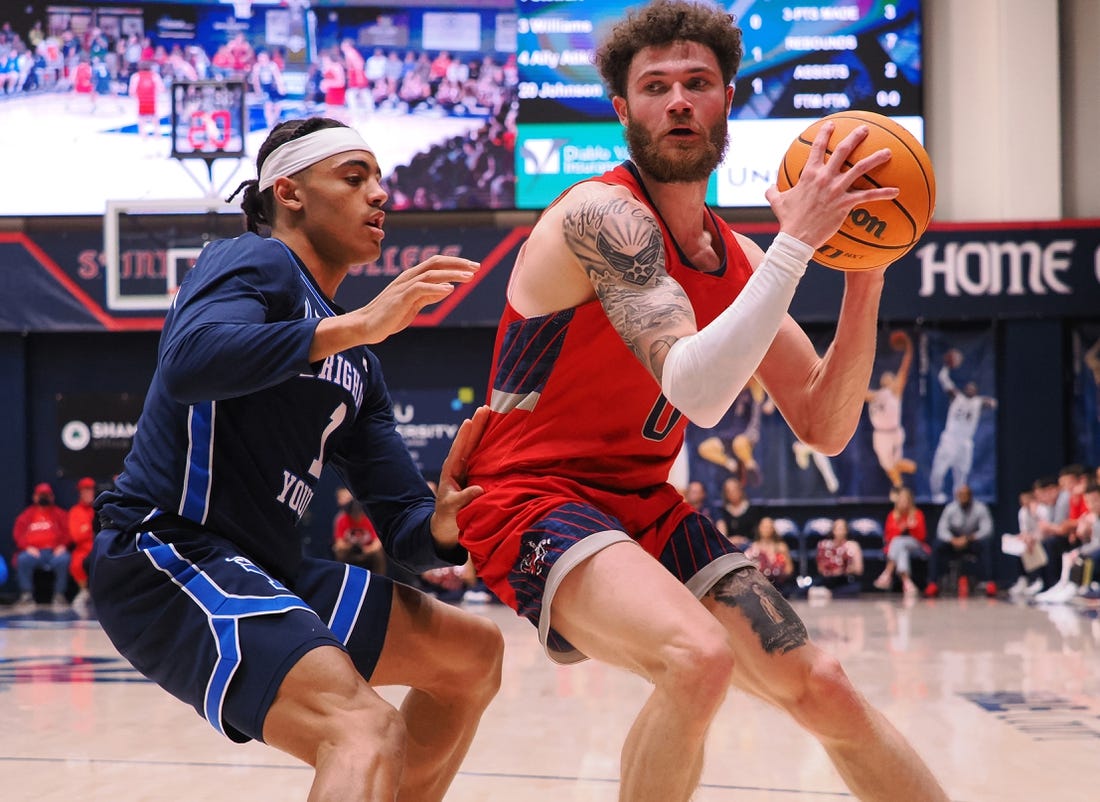 Feb 18, 2023; Moraga, California, USA; St. Mary's Gaels guard Logan Johnson (0) controls the ball against BYU Cougars guard Trey Stewart (1) during the first half at University Credit Union Pavilion. Mandatory Credit: Kelley L Cox-USA TODAY Sports