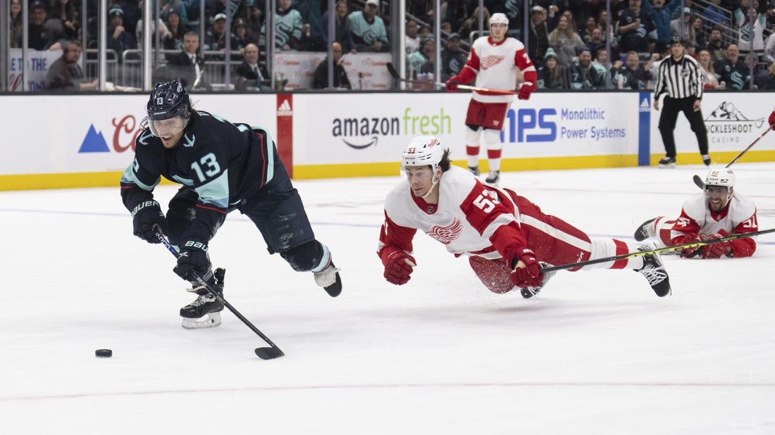 Feb 18, 2023; Seattle, Washington, USA; Seattle Kraken forward Brandon Tanev skates against Detroit Red Wings defenseman Moritz Seider (53) during the third period at Climate Pledge Arena. Mandatory Credit: Stephen Brashear-USA TODAY Sports