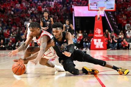 Feb 19, 2023; Houston, Texas, USA; Houston Cougars guard Marcus Sasser (0) and Memphis Tigers guard Keonte Kennedy (1) scrambles for a loose ball during the first half at Fertitta Center. Mandatory Credit: Maria Lysaker-USA TODAY Sports