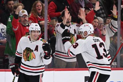 Feb 19, 2023; Chicago, Illinois, USA;  Chicago Blackhawks forward Patrick Kane (88) celebrates with forward Max Domi (13) after scoring his third goal of the game in the second period against the Toronto Maple Leafs at United Center. Mandatory Credit: Jamie Sabau-USA TODAY Sports
