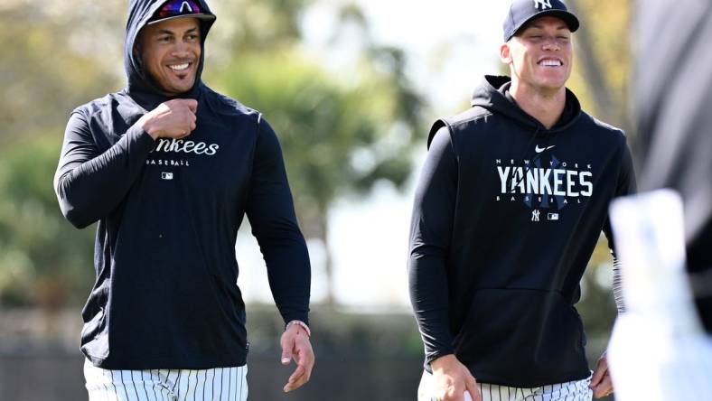 Feb 21, 2023; Tampa, FL, USA; New York Yankees outfielder Aaron Judge (99) and outfielder Giancarlo Stanton (27) warm up during spring training. Mandatory Credit: Jonathan Dyer-USA TODAY Sports