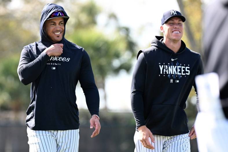 Feb 21, 2023; Tampa, FL, USA; New York Yankees outfielder Aaron Judge (99) and outfielder Giancarlo Stanton (27) warm up during spring training. Mandatory Credit: Jonathan Dyer-USA TODAY Sports