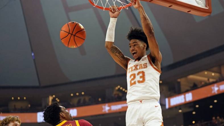 Feb 21, 2023; Austin, Texas, USA; Texas Longhorns forward Dillon Mitchell (23) dunks over Iowa State Cyclones guard Gabe Kalscheur (22) and center Osun Osunniyi (21) during the first half at Moody Center. Mandatory Credit: Scott Wachter-USA TODAY Sports