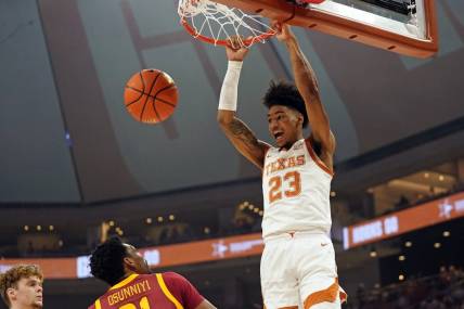 Feb 21, 2023; Austin, Texas, USA; Texas Longhorns forward Dillon Mitchell (23) dunks over Iowa State Cyclones guard Gabe Kalscheur (22) and center Osun Osunniyi (21) during the first half at Moody Center. Mandatory Credit: Scott Wachter-USA TODAY Sports