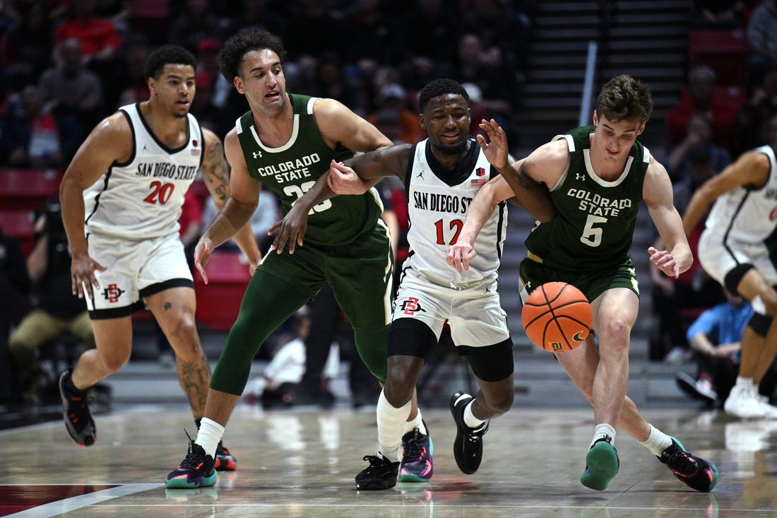 Feb 21, 2023; San Diego, California, USA; San Diego State Aztecs guard Darrion Trammell (12) and Colorado State Rams guard Baylor Hebb (5) battle for a loose ball during the first half at Viejas Arena. Mandatory Credit: Orlando Ramirez-USA TODAY Sports