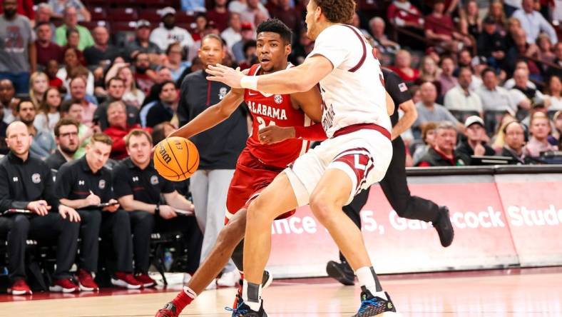 Feb 22, 2023; Columbia, South Carolina, USA; Alabama Crimson Tide forward Brandon Miller (24) drives around South Carolina Gamecocks forward Benjamin Bosmans-Verdonk (31) in the first half at Colonial Life Arena. Mandatory Credit: Jeff Blake-USA TODAY Sports