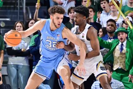 Feb 22, 2023; South Bend, Indiana, USA; North Carolina Tar Heels forward Pete Nance (32) dribbles as Notre Dame Fighting Irish guard Trey Wertz (3) defends in the second half at the Purcell Pavilion. Mandatory Credit: Matt Cashore-USA TODAY Sports