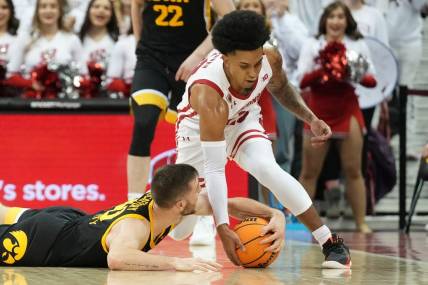 Feb 22, 2023; Madison, Wisconsin, USA; Wisconsin Badgers guard Chucky Hepburn (23) and Iowa Hawkeyes guard Connor McCaffery (30) go after a loose ball during the second half at the Kohl Center. Mandatory Credit: Kayla Wolf-USA TODAY Sports